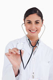 Close up of smiling female doctor using stethoscope
