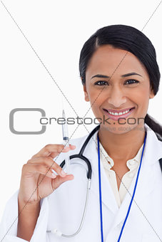 Close up of smiling female doctor with syringe