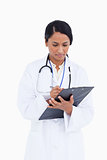 Close up of female physician taking notes