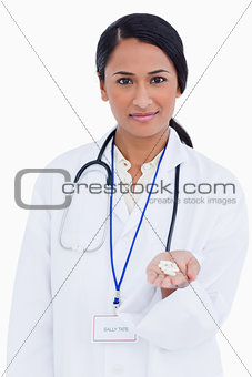 Close up of female physician holding pills in her palm
