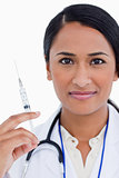 Close up of female physician with syringe
