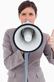 Close up of angry female entrepreneur shouting through megaphone