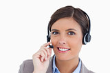 Close up of smiling female call center agent adjusting her heads