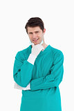 Close up of male doctor wearing scrubs in thinkers pose