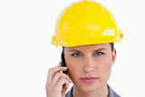 Close up of serious female architect on her cellphone