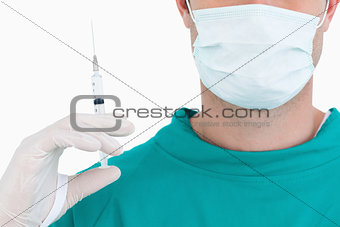 Close up of doctor with syringe wearing scrubs
