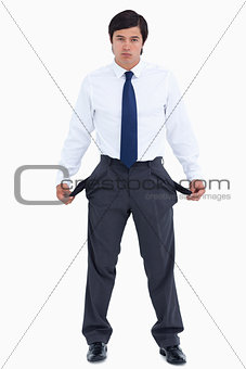 Sad tradesman showing his empty pockets