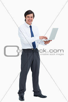 Side view of smiling tradesman with his laptop