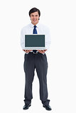 Smiling tradesman presenting screen of his laptop