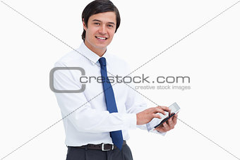 Side view of smiling tradesman with his tablet computer