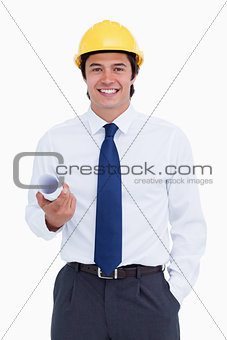 Smiling male architect with helmet and plans