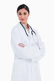 Female doctor standing with her arms folded