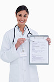 Smiling female doctor pointing at form
