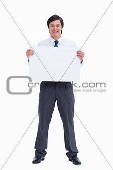 Smiling tradesman holding blank sign