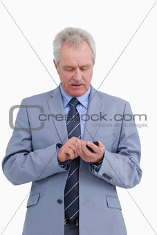 Mature tradesman writing a text message