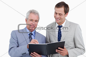 Smiling tradesmen with notebook and pen