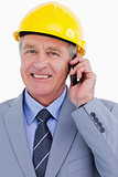 Close up of smiling mature architect on his cellphone