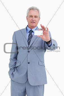 Mature tradesman showing his business card
