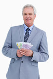 Smiling mature tradesman with bank notes in his hands
