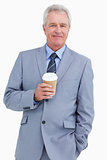Smiling mature tradesman with paper cup