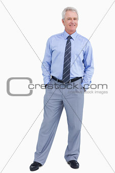 Smiling mature tradesman with his hands in his pockets