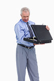 Mature tradesman looking into his suitcase