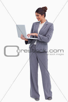 Smiling female entrepreneur working on her laptop
