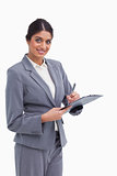 Smiling female entrepreneur with clipboard and pen