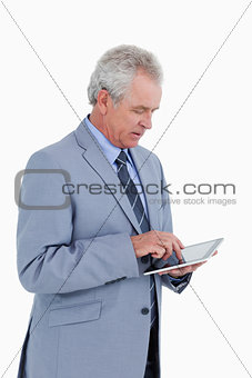 Side view of mature tradesman using tablet computer