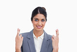 Smiling female entrepreneur with her fingers crossed