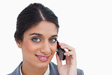 Close up of smiling female entrepreneur on her mobile phone