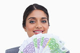 Close up of smiling female entrepreneur with bank notes