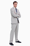 Serious businessman standing with his arms folded