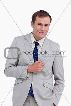 Smiling businessman standing with hand in his pocket