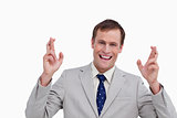 Close up of smiling businessman with his fingers crossed