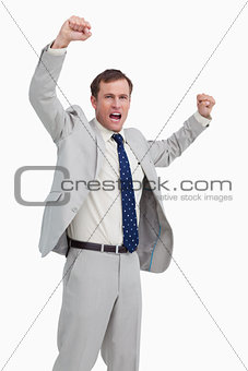 Celebrating businessman with his arms up
