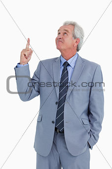 Mature tradesman pointing and looking up