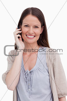 Close up of smiling young woman on her cellphone