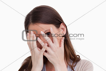 Close up of woman hiding behind her hands
