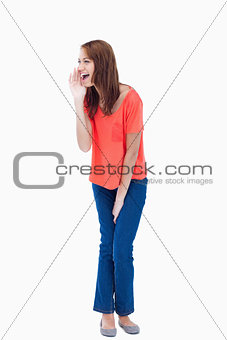 Young woman screaming to call someone