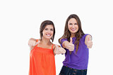 Woman standing up her thumbs turned to the side while her friend