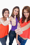 Three teenage girls proudly showing their happiness by putting t