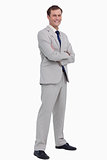 Smiling businessman standing with his arms folded