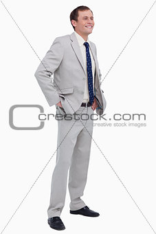 Smiling businessman with hands in his pockets