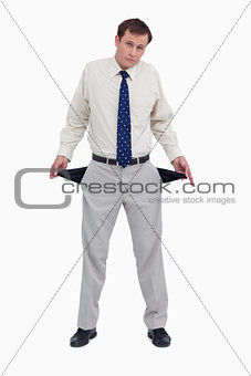 Sad businessman showing his empty pockets