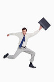Cheerful jumping businessman with his suitcase