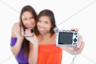 Digital camera taking a picture of two teenagers