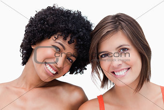 Teenage girls smiling and posing against a white background