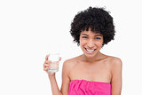 Teenager showing a beaming smile while holding a glass of water