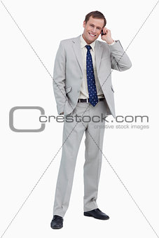 Smiling businessman on his mobile phone